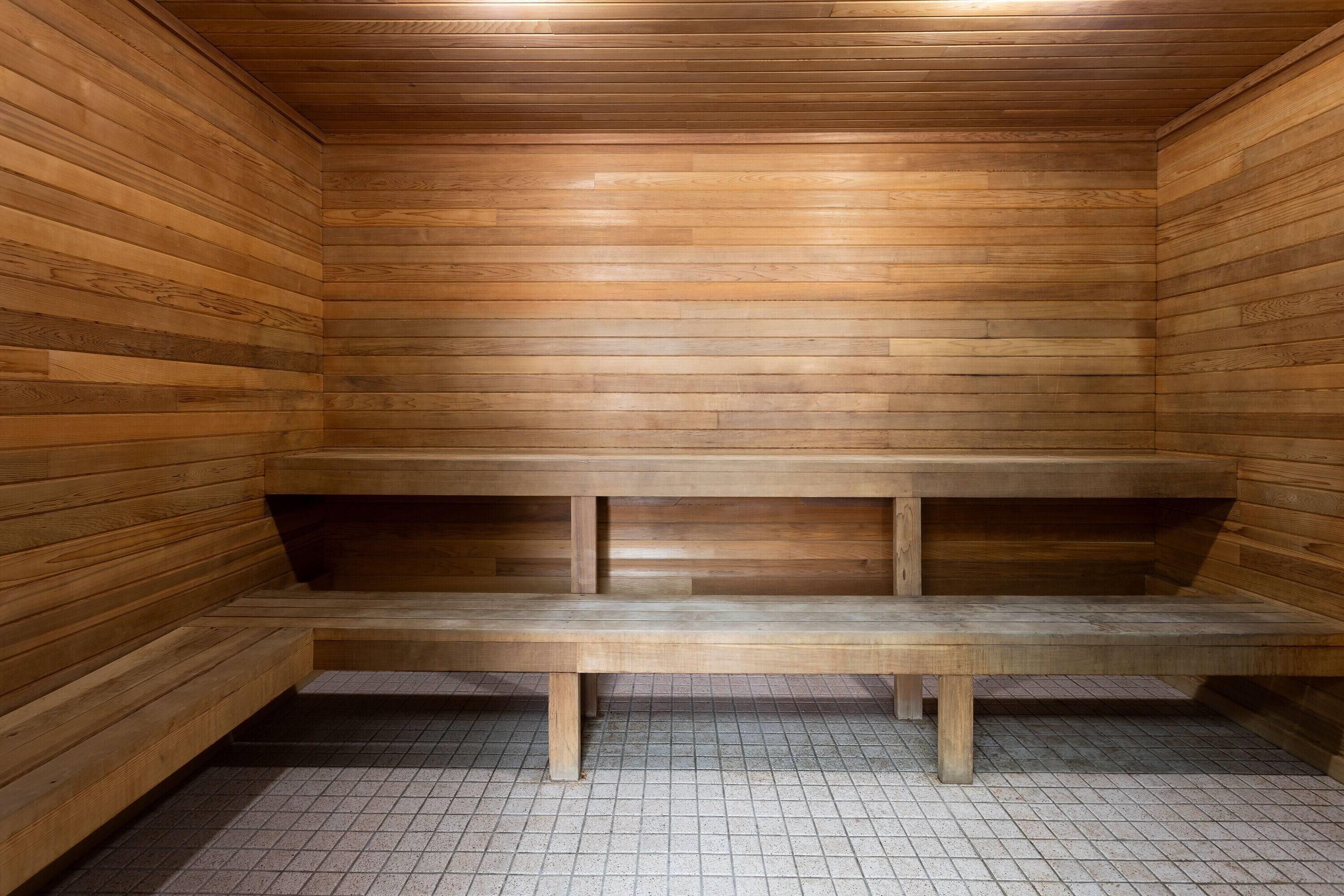 A sauna with wooden walls and benches.