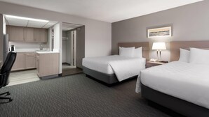 A hotel room with two beds, a desk, and a kitchenette. - Travelodge by Wyndham Grande Prairie (Grande Prairie)