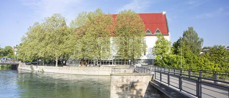 A bridge over a river with a building in the background.