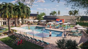 Una piscina al aire libre, sillones reclinables de piscina