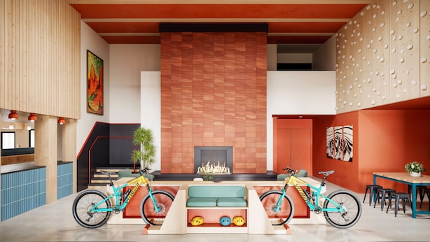 A spacious living area with a large fireplace, two bicycles, a sofa, and a dining table with chairs. - LOGE St. George (St. George)