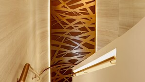 A modern interior with a geometric patterned wall and a minimalist door design. - Prudential Hotel (Kowloon)