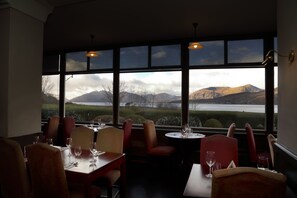 Enjoy meals with a view of the surrounding mountains and water from this dining area.