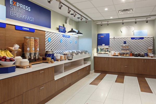 A breakfast area with labeled sections for cereal, hot food, and bakery.