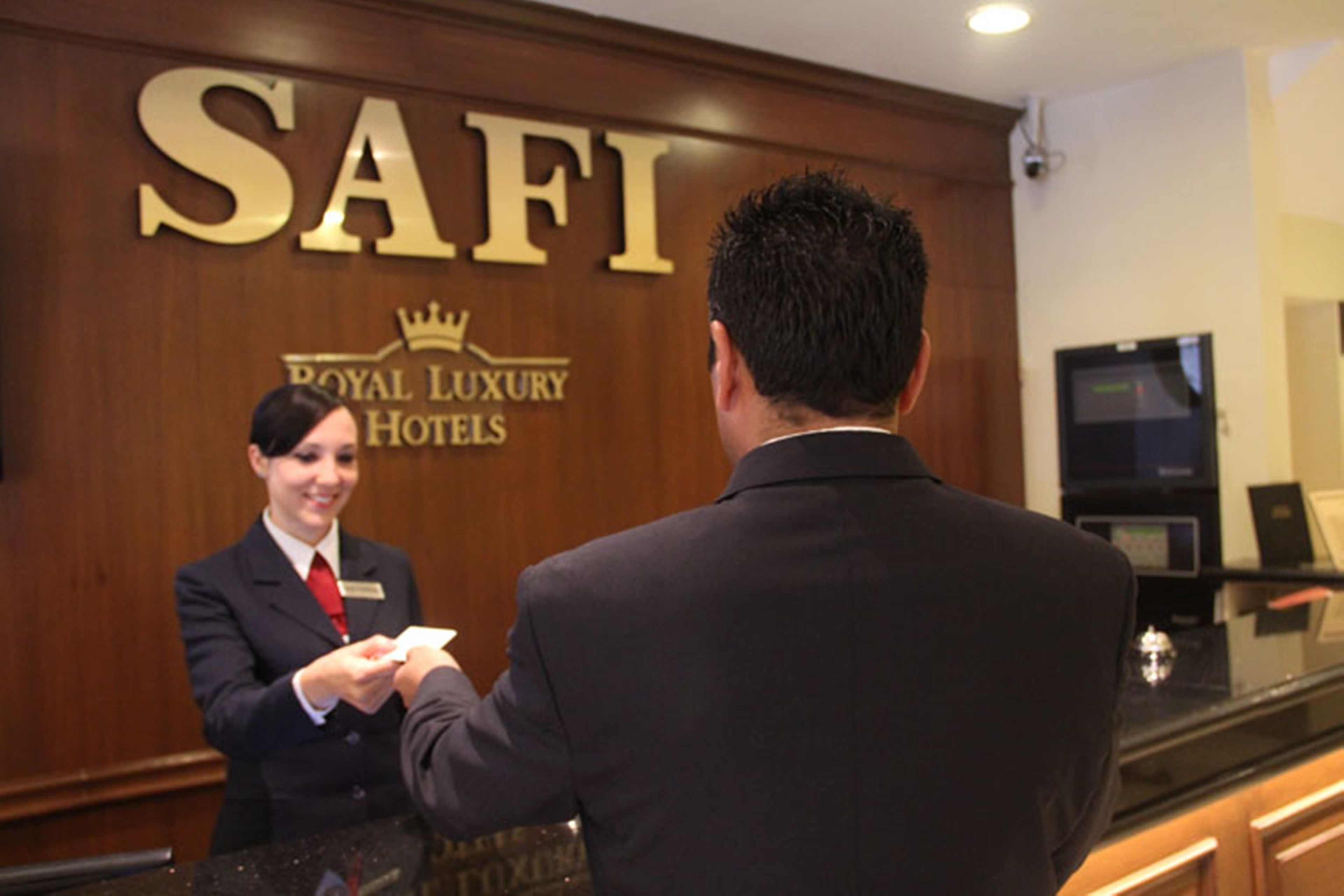 A reception area with a sign reading "SAFI Royal Luxury Hotels".