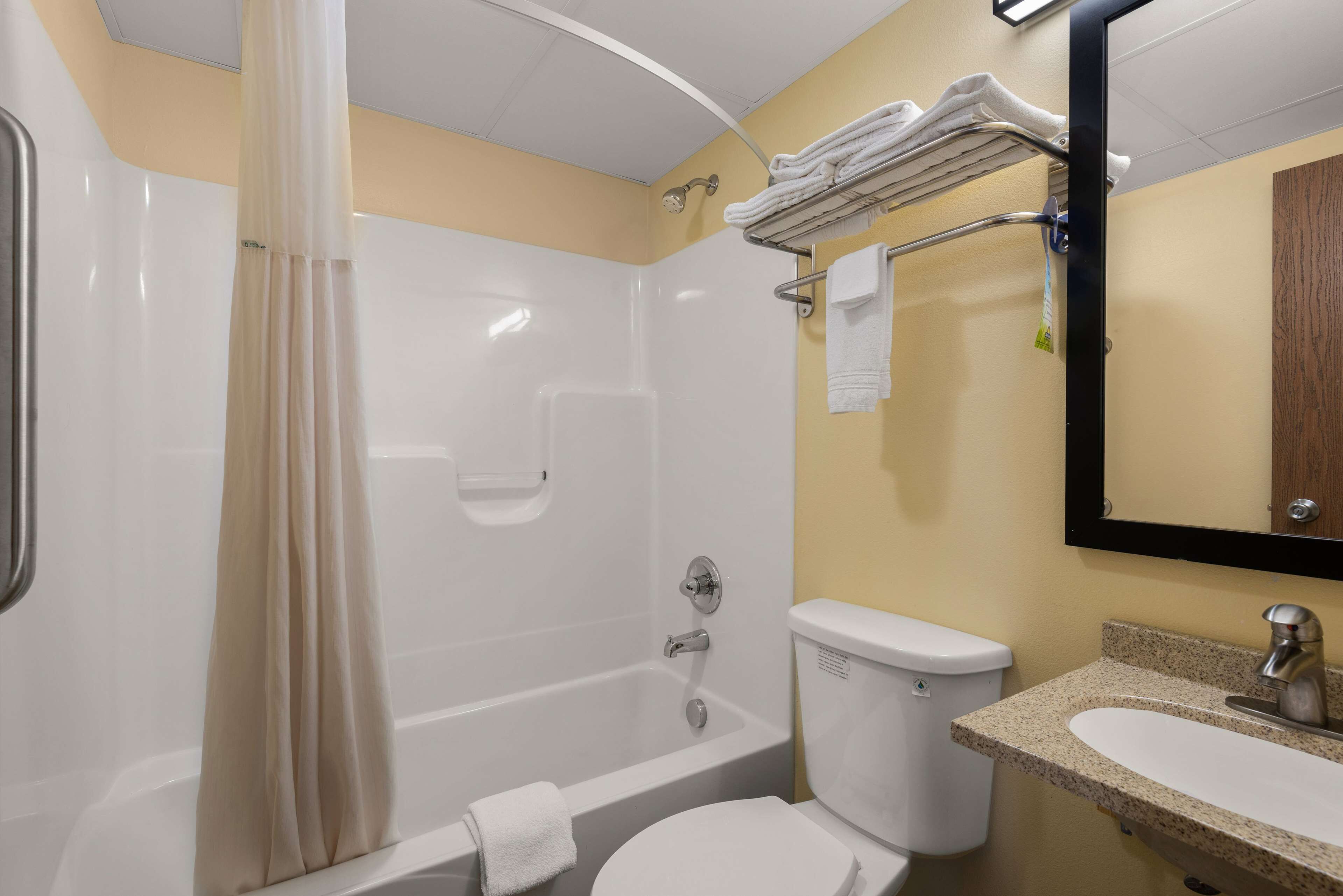 A bathroom with a bathtub, toilet, and sink.
