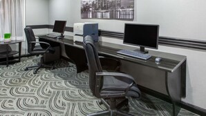 A hotel office with a long desk, two monitors, a printer, and two chairs. - Americas Best Value Inn Canton (Canton)