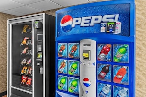 A vending machine with Pepsi branding and a selection of beverages.