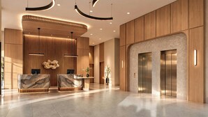 A modern lobby with a reception desk, a marble counter, a wooden reception area, and an elevator. - Red Roof Inn PLUS+ Vancouver Airport (Richmond)