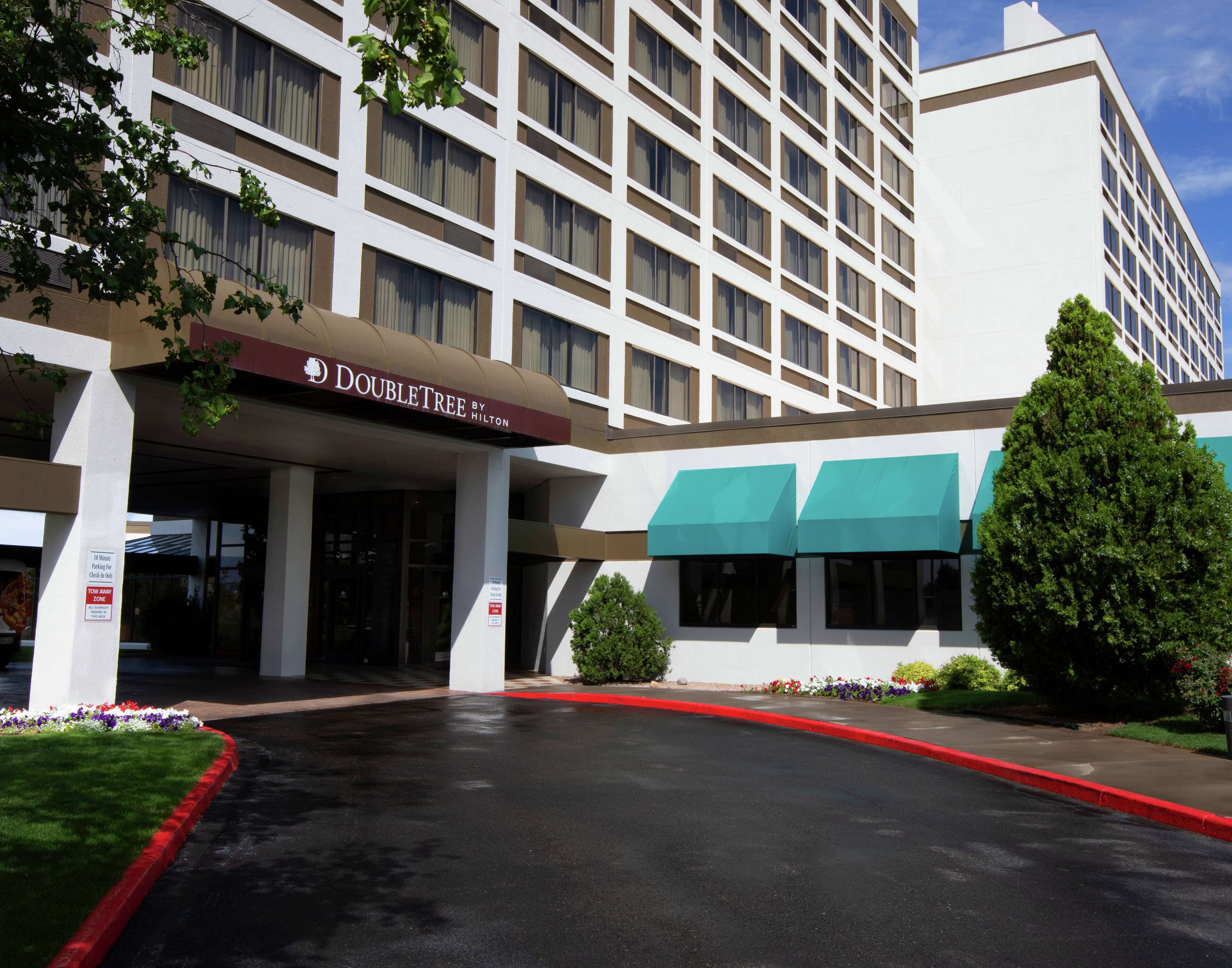 A hotel entrance with a sign for 'Doubletree by Hilton'.