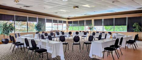 A conference room with tables and chairs arranged for a meeting.