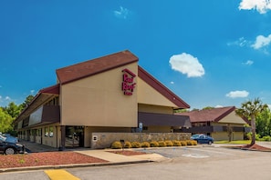A Red Roof Inn with a two-story structure, a stone facade, and a parking lot. - Red Roof Inn Columbia East - Ft Jackson (Columbia)