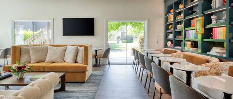 A modern living room with a sofa, coffee table, and a bookshelf.