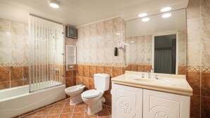 A bathroom with a bathtub, toilet, and sink. - JAZ Pyramids Resort (Giza)