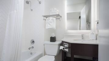 A modern bathroom with a bathtub, toilet, and sink.