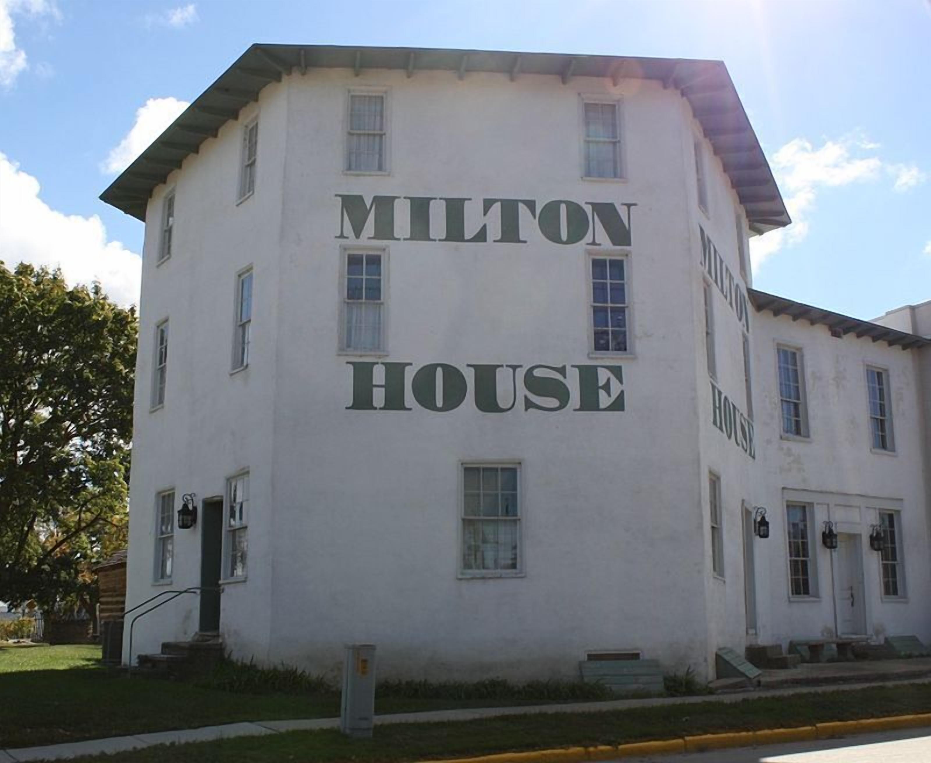 A two-story building with the name "MILTON HOUSE" prominently displayed on the facade.