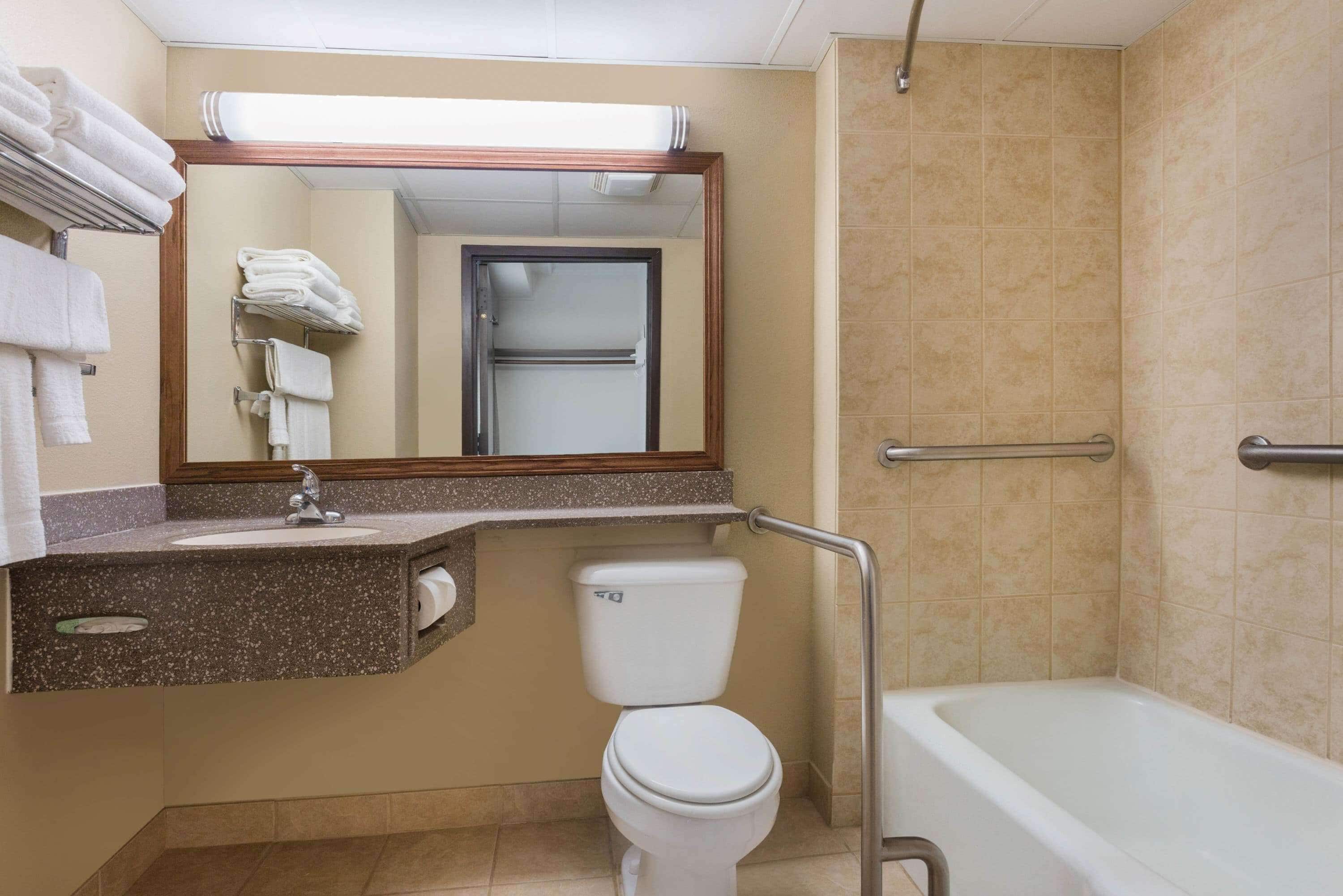 A bathroom with a toilet, sink, and bathtub.