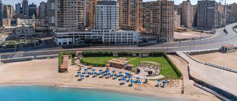 A hotel with a pool area, surrounded by high-rise buildings.