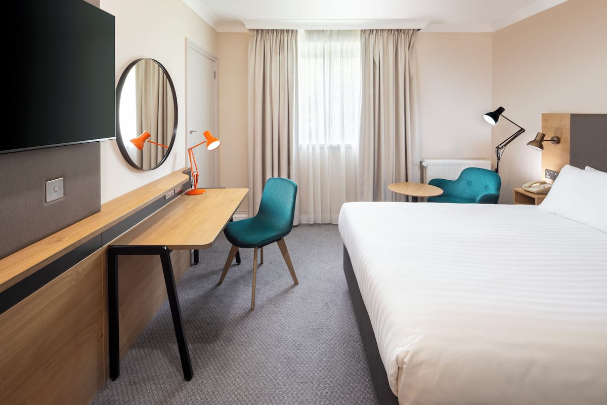 Hypo-allergenic bedding, desk, laptop workspace, blackout curtains