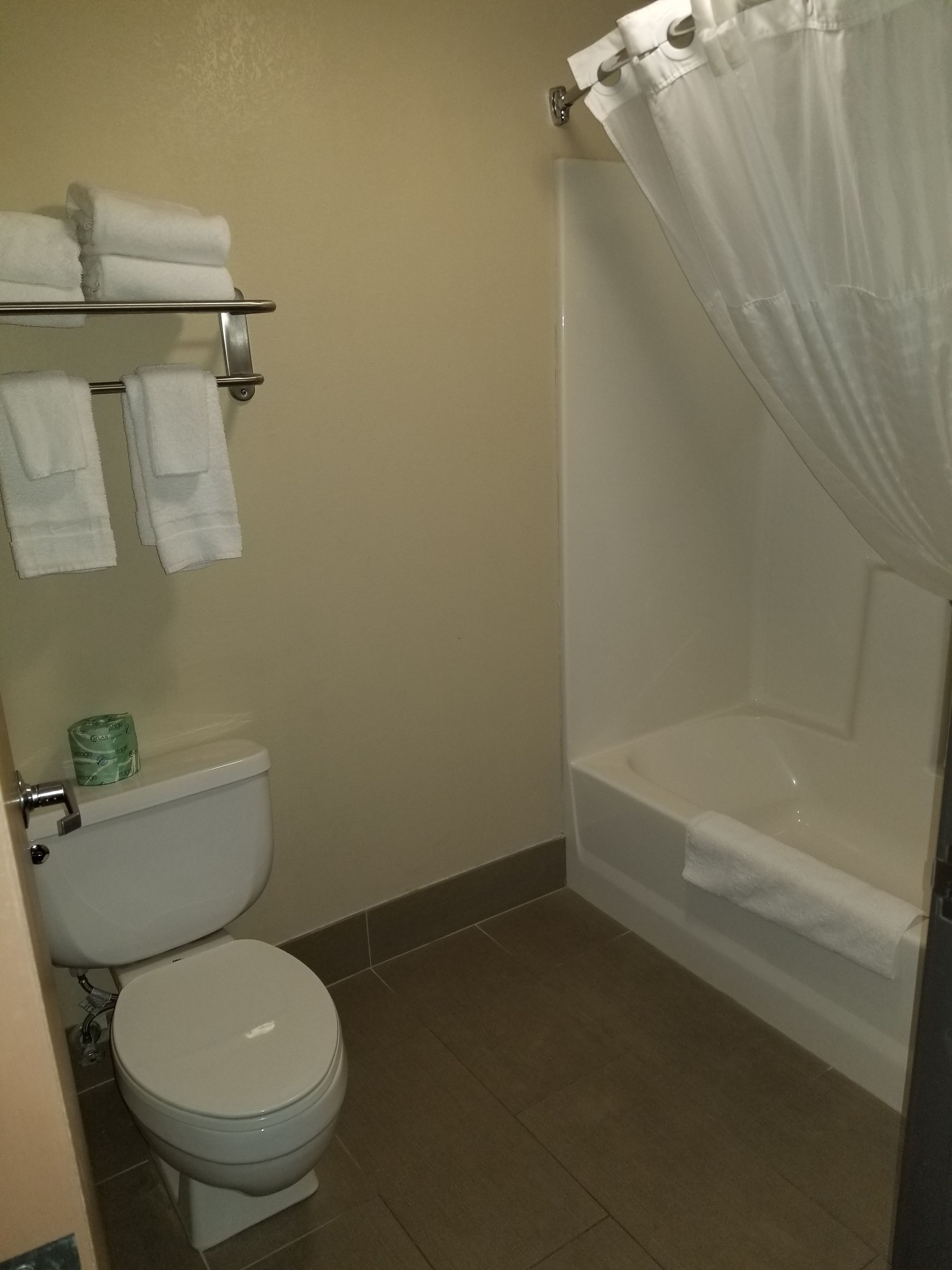 combined shower/bathtub, designer toiletries, hair dryer, towels