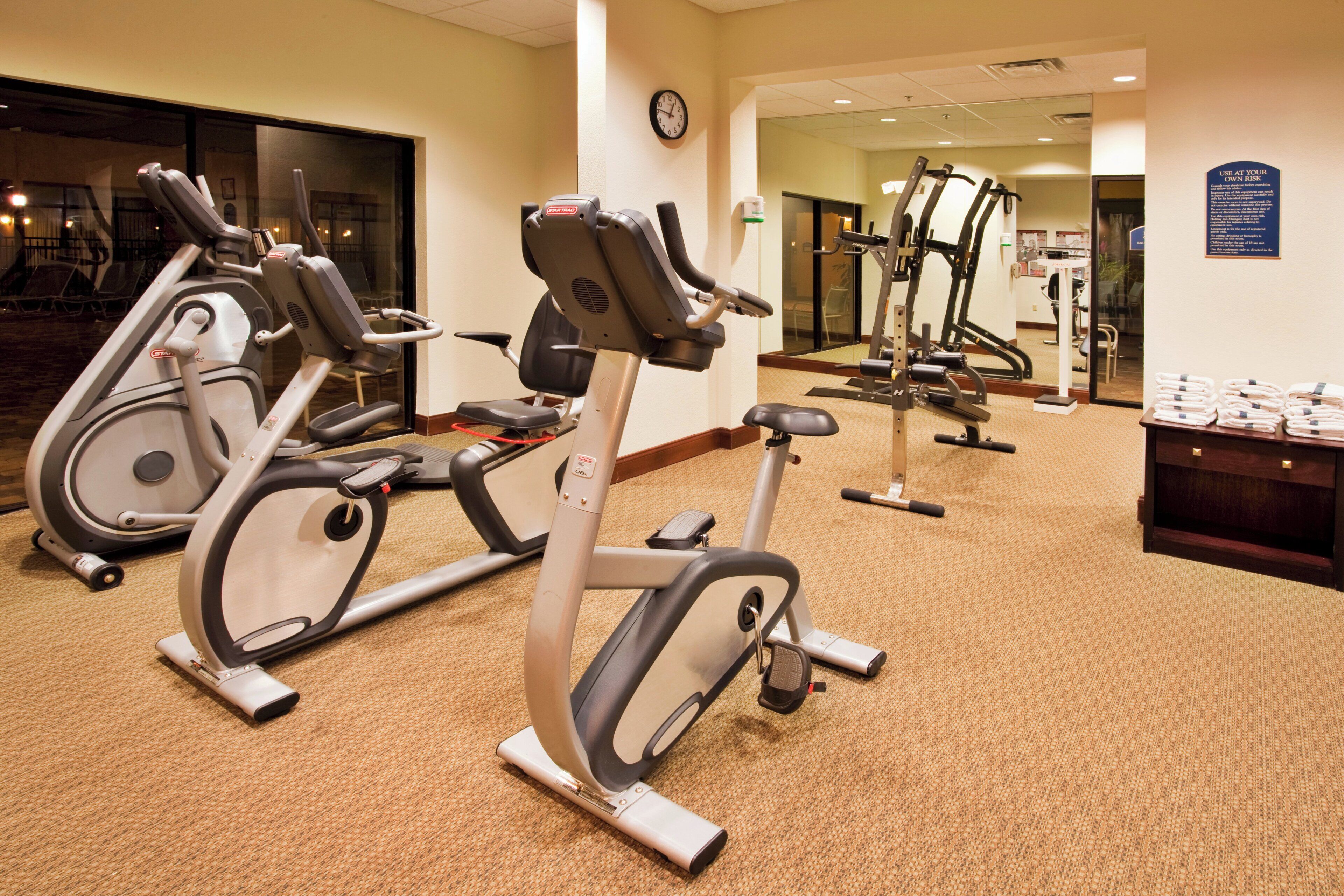 A gym with stationary bikes and cardio equipment.
