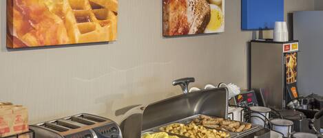 A buffet setup with various food items, a toaster, and a coffee machine.