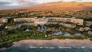 A resort with multiple buildings, a beach, and a mountainous backdrop. - Grand Wailea Maui, A Waldorf Astoria Resort (Kihei)