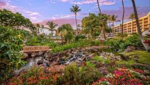 A resort with a pond, a wooden bridge, and lush greenery. - Grand Wailea Maui, A Waldorf Astoria Resort (Kihei)