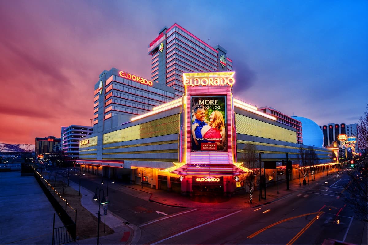 A large hotel with a prominent 'Eldorado' sign, multiple floors, and a large billboard advertising Caesars Rewards.