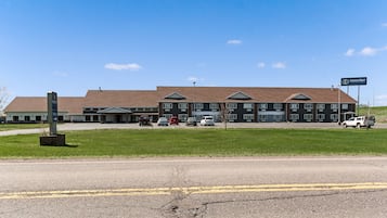 A multi-story hotel with a brick facade and a flat roof.