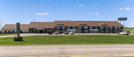 A multi-story hotel with a brick facade and a flat roof.