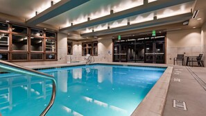 Relax by the rectangular pool surrounded by a tiled deck.