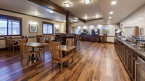 Enjoy meals in this inviting dining area with high ceilings, large windows, and comfortable seating.