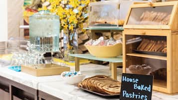 A bakery display with bread and pastries, a coffee station, and a sign indicating 'House Baked Pastries'.