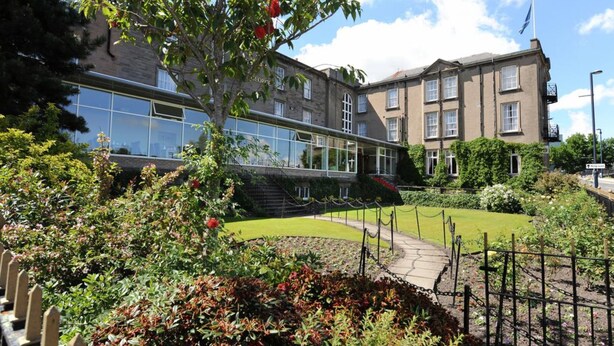 A building with a glass facade and a garden in front. - The Royal George Hotel (Perth)