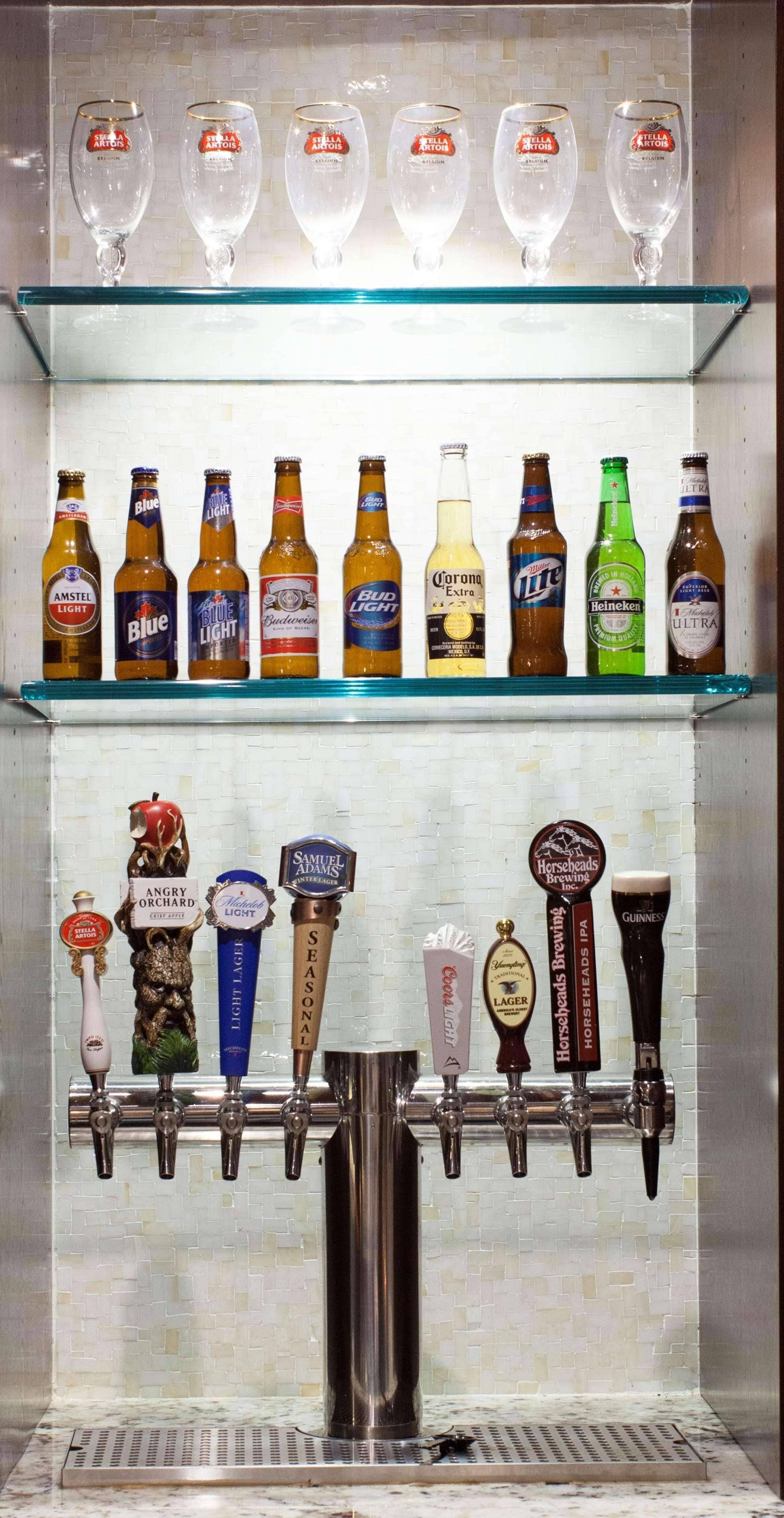 A bar area with multiple beer taps and bottles.