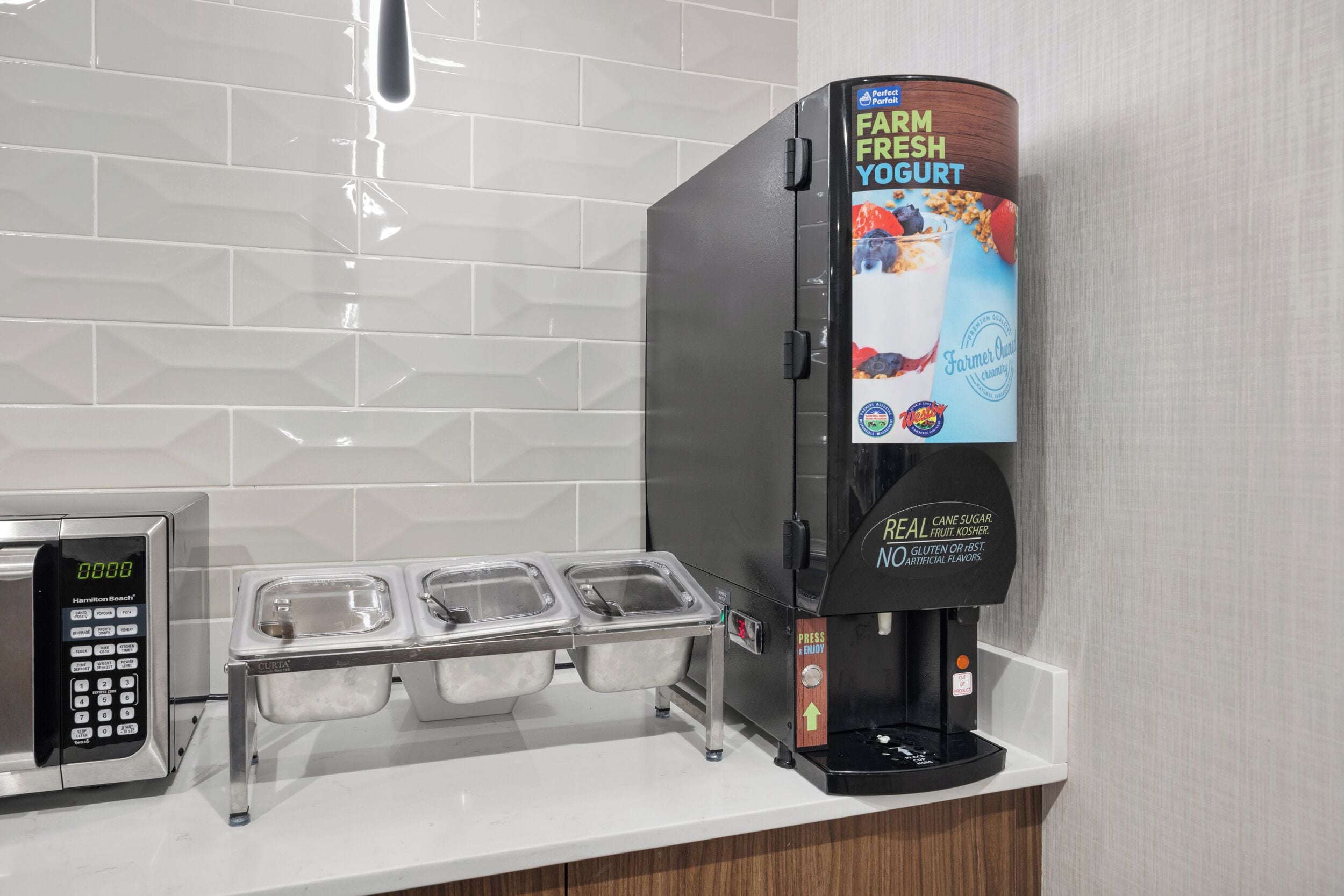A self-serve yogurt station with a digital scale, a refrigerated display, and a dispenser.