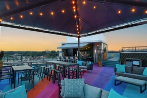 An outdoor patio area with tables, chairs, a bar, and a pool. - The Ven at Embassy Row, Washington, D.C., a Tribute Portfolio Hotel (Washington)