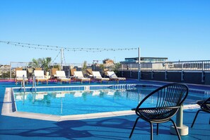 Seasonal outdoor pool, open 9:00 AM to 10:00 PM, sun loungers