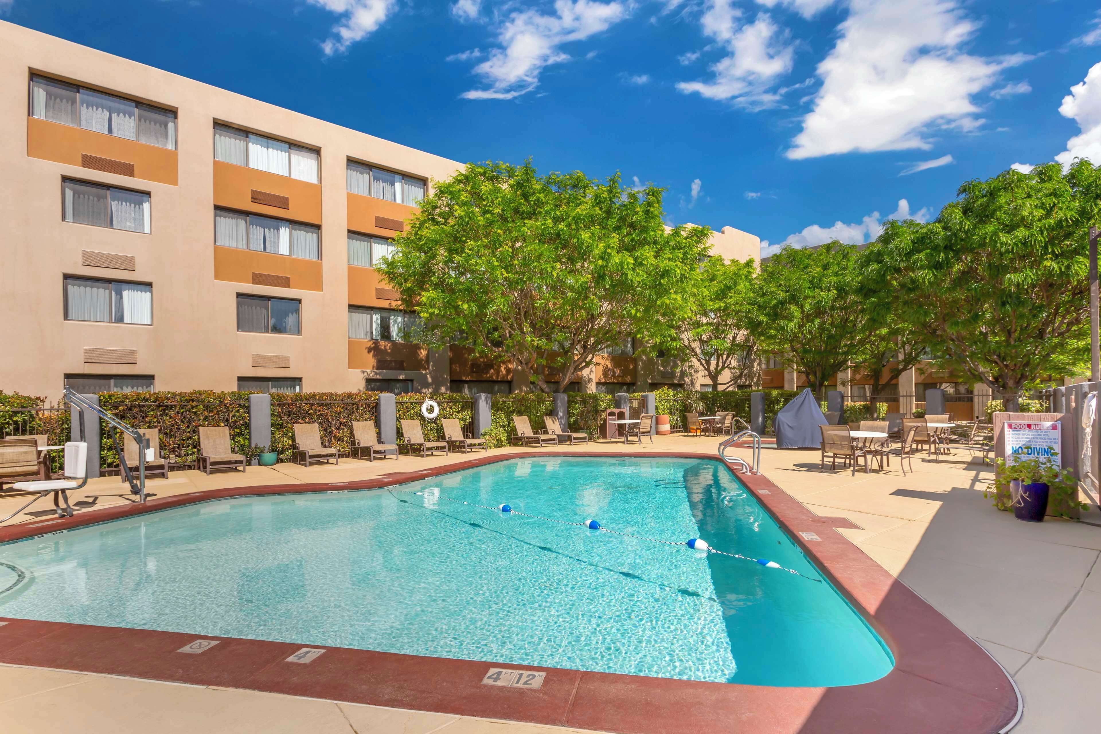 outdoor pool, open 7 am to 10 pm, pool umbrellas, pool loungers