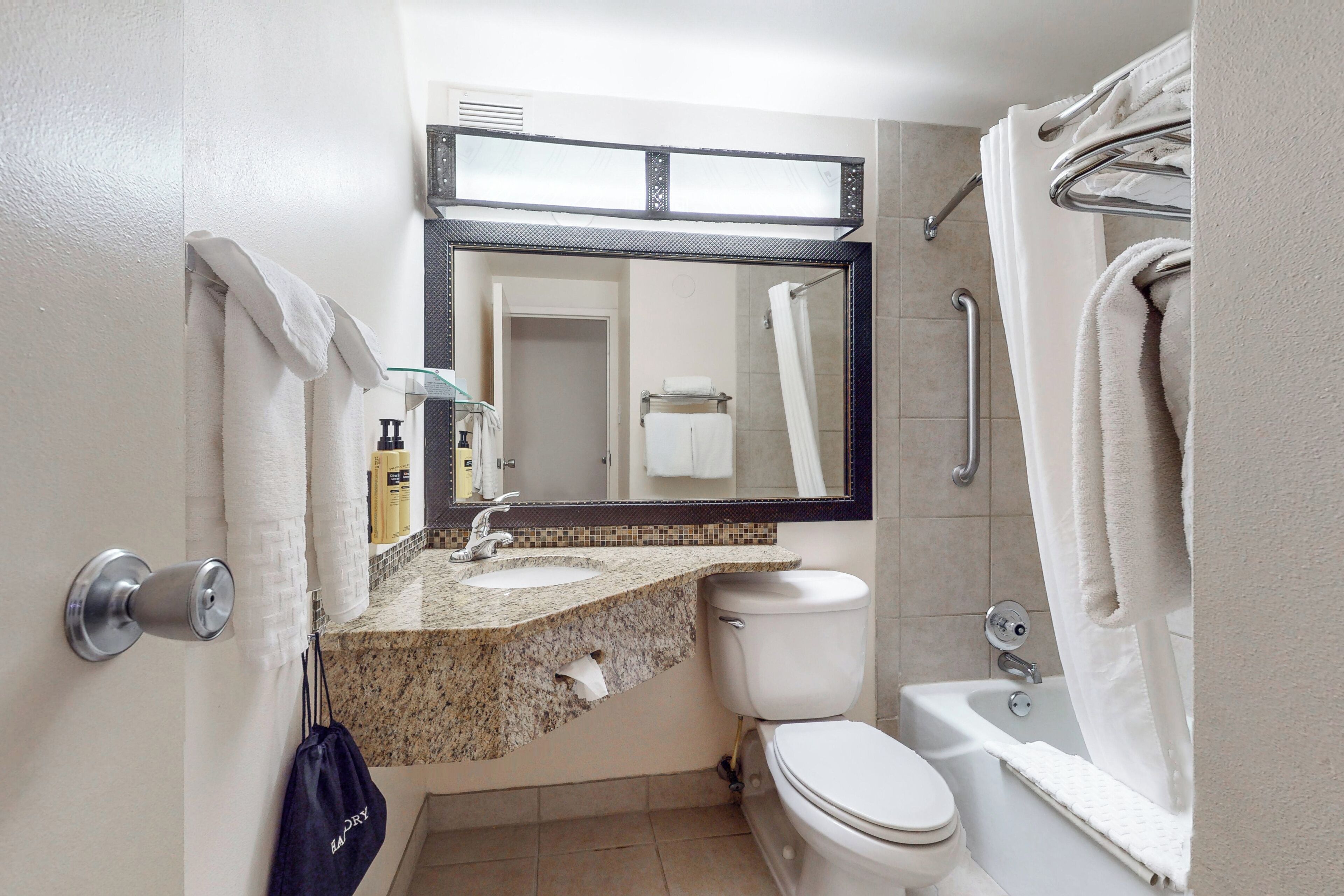 A bathroom with a sink, toilet, and bathtub.