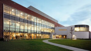 A modern building with large glass windows, a brick facade, and a curved section. - DoubleTree by Hilton Hotel Nanuet (Nanuet)