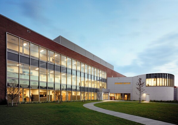 A modern building with large glass windows, a brick facade, and a curved section. - DoubleTree by Hilton Hotel Nanuet (Nanuet)
