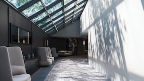 A modern interior with a skylight, seating area, and a patterned floor. - Marriott Chicago Schaumburg (Schaumburg)