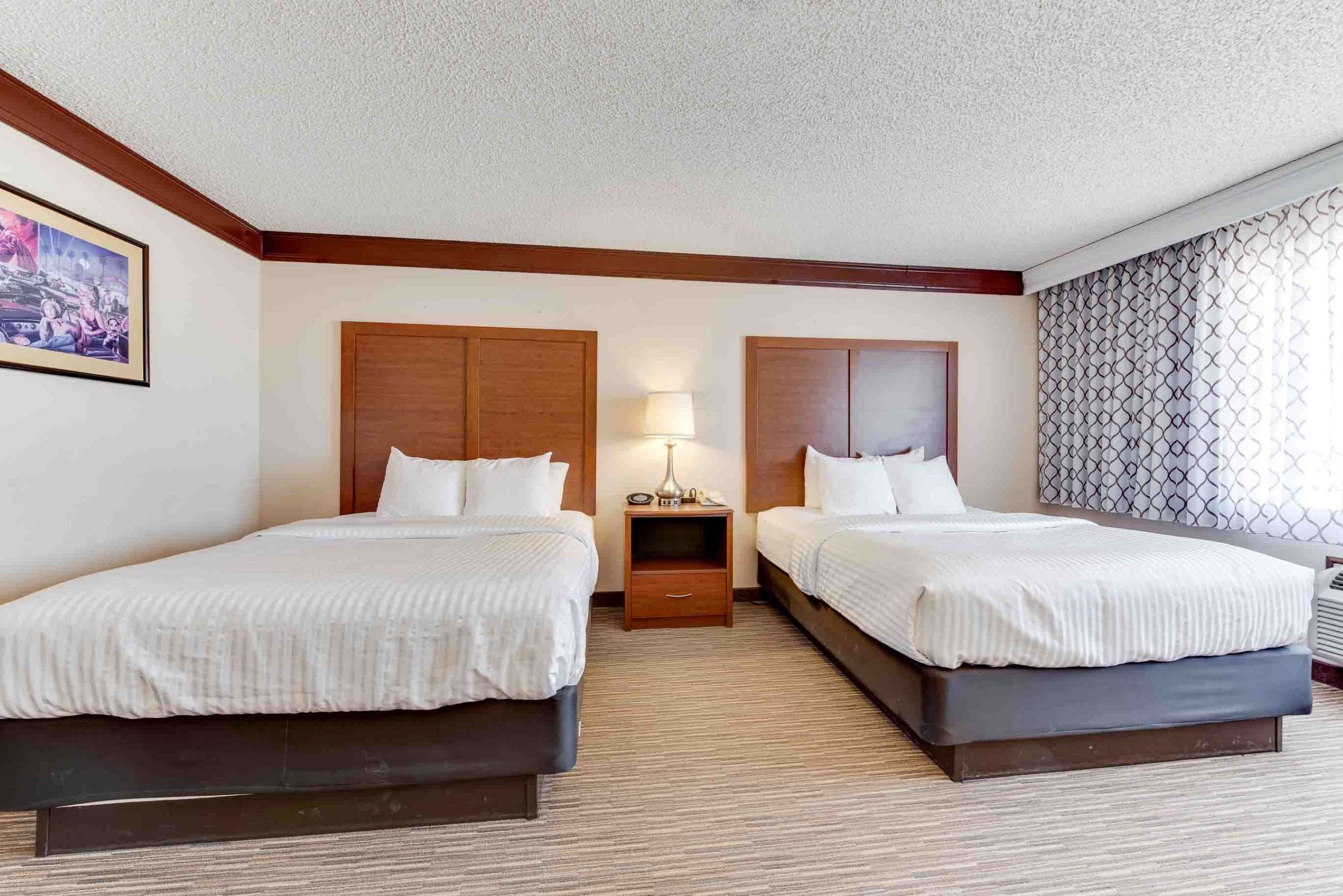 standard room, 2 queen beds, non smoking, refrigerator & microwave (movie view) | 1 bedroom, desk, blackout curtains, iron/ironing board