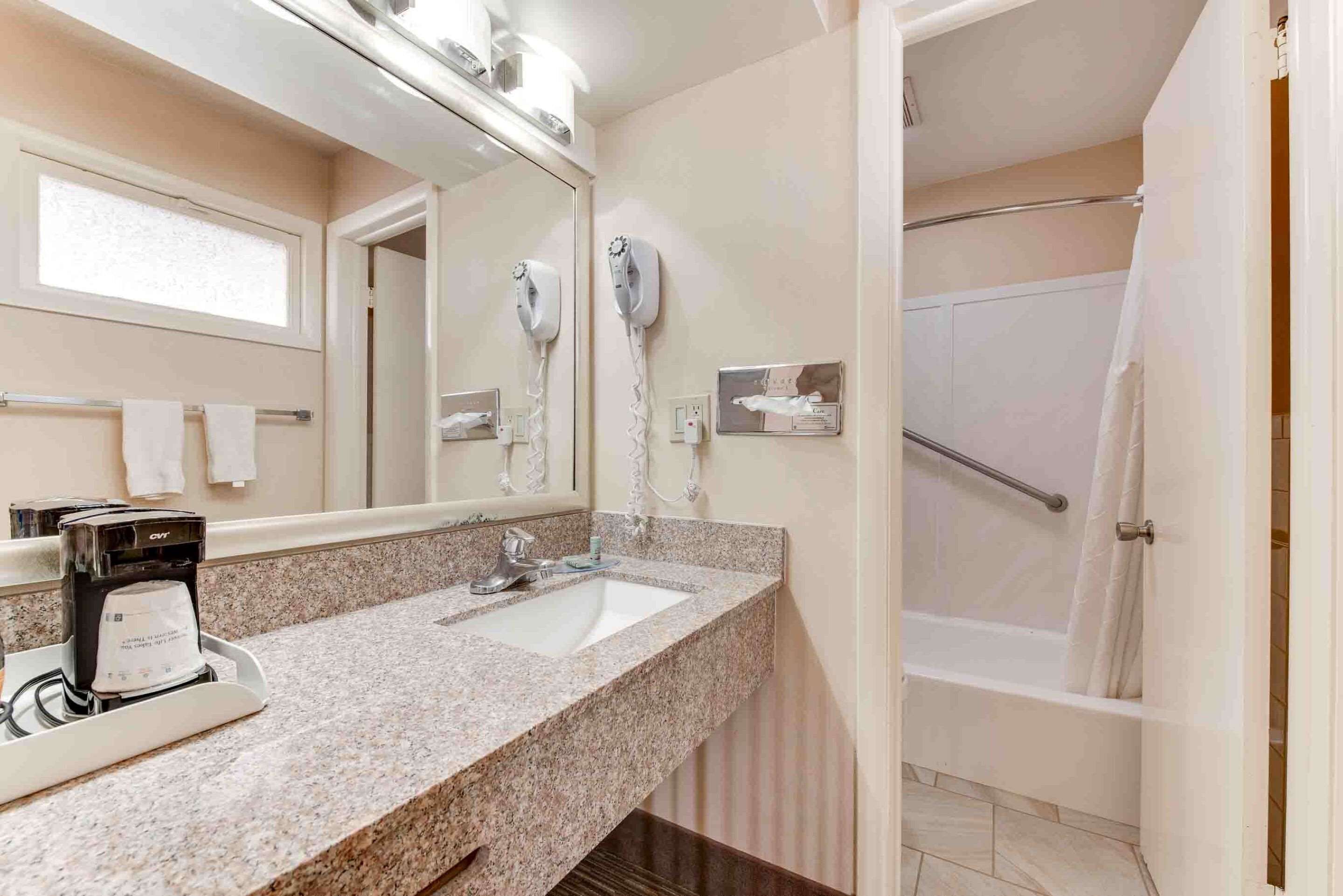 standard room, 1 king bed, non smoking, refrigerator & microwave (movie view from the bed) | bathroom | free toiletries, hair dryer, towels