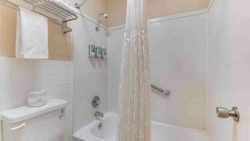 A bathroom with a shower, toilet, and sink.