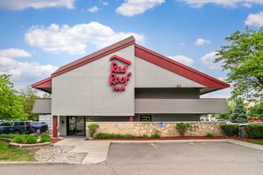 A Red Roof Inn with a red roof and a stone facade.