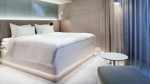 A modern hotel room with a large bed, a bedside table, and a wall-mounted light fixture. - Radisson Blu Royal Hotel Helsinki (Helsinki)