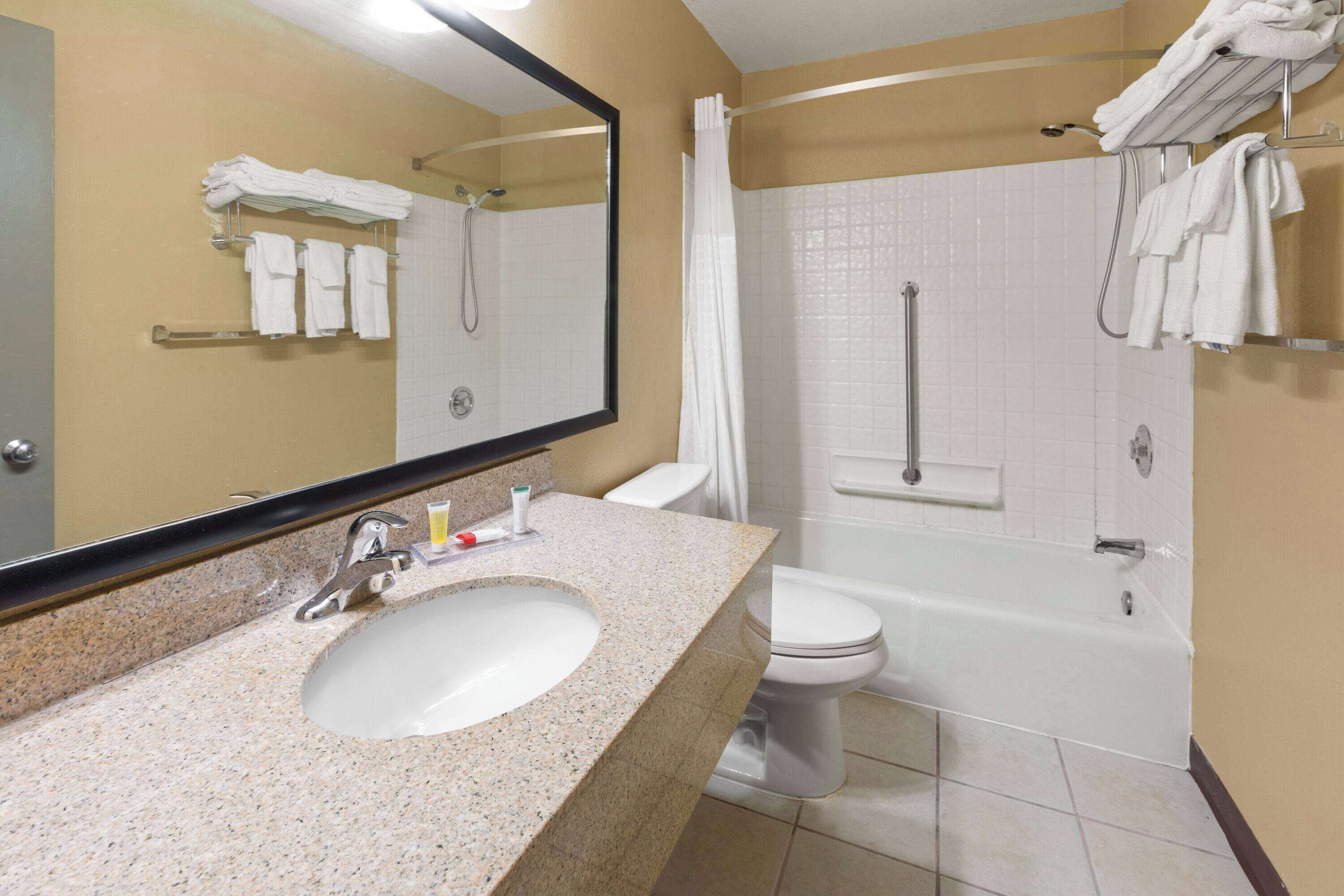 A bathroom with a sink, toilet, and bathtub.